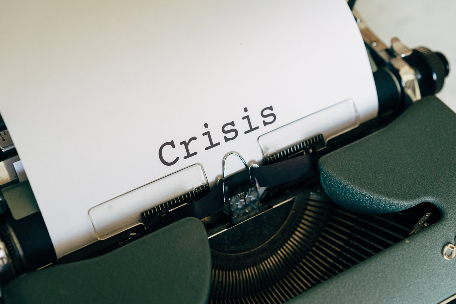 Typewriter letters spelling "Crisis"
